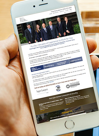Screenshot of Small Snell Weiss & Comfort law firm website on mobile phone laying on laptop computer. 